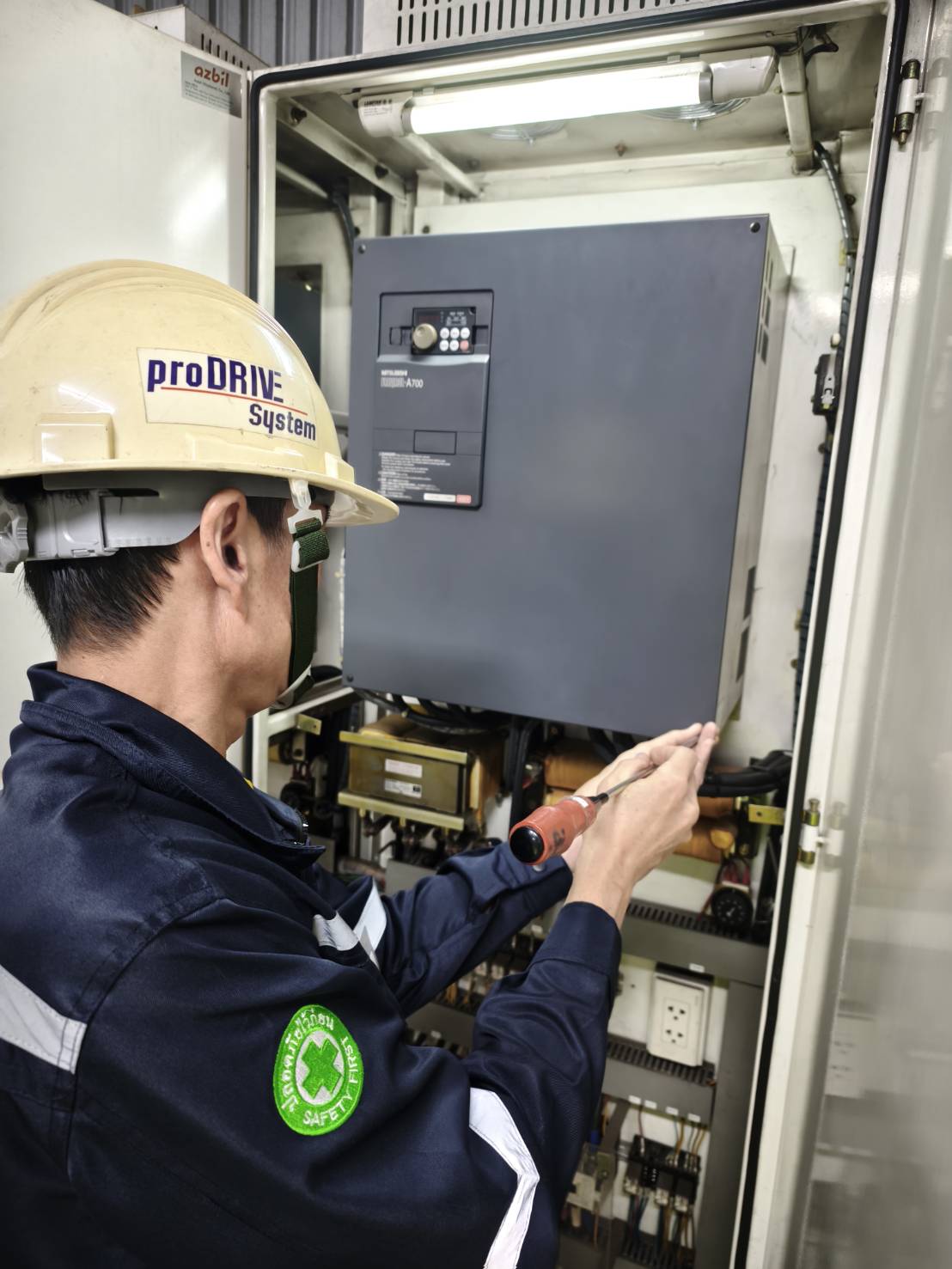 วิศวกร Prodrive System ตรวจสอบอินเวอร์เตอร์ Mitsubishi ในตู้ควบคุมโรงงาน